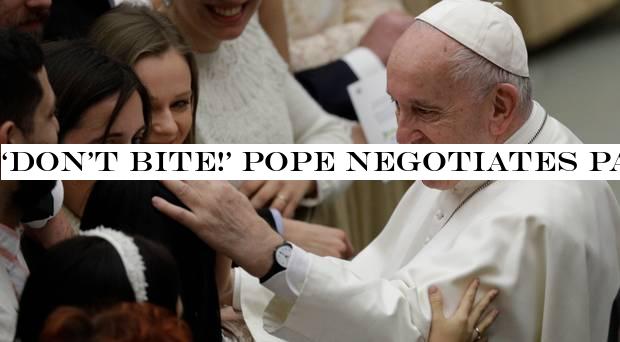 ‘Don&t bite!& Pope negotiates papal kiss after hand-slapping controversy